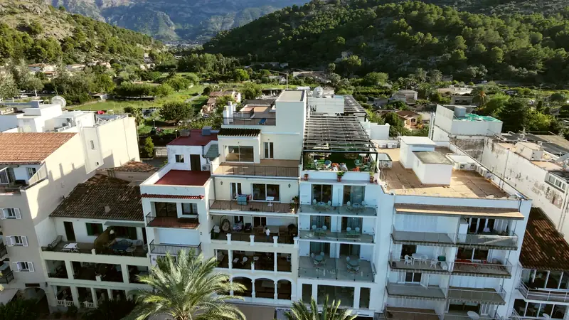 Edificios blancos con la sierra detrás